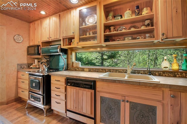 kitchen with tile counters, light hardwood / wood-style flooring, stainless steel appliances, wooden ceiling, and sink