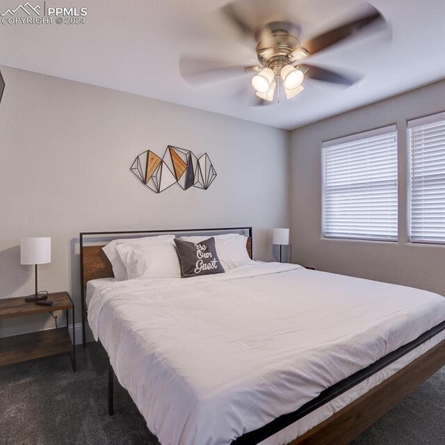 bedroom featuring dark colored carpet and ceiling fan