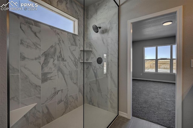 bathroom featuring a healthy amount of sunlight and a tile shower