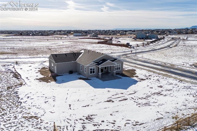 snowy aerial view featuring a rural view