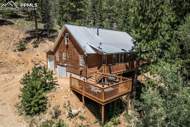 rear view of property with a wooden deck