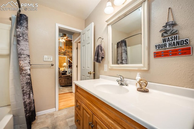 bathroom featuring ceiling fan, vanity, shower / bath combo with shower curtain, and tile patterned floors