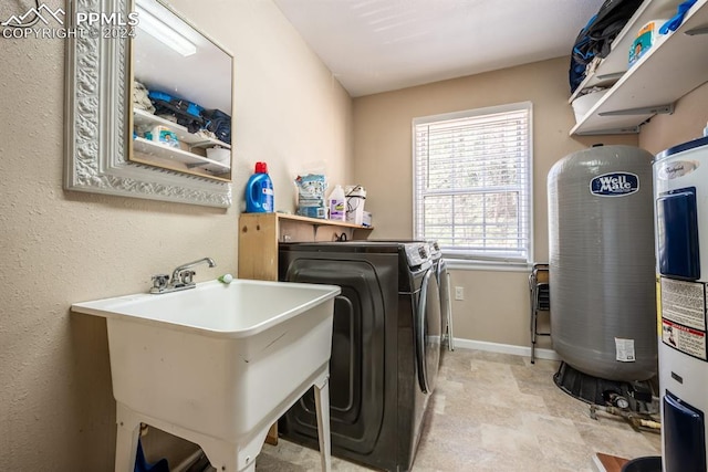 washroom with separate washer and dryer, light tile patterned floors, and sink