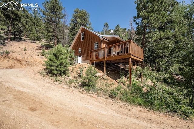 rear view of property featuring a deck