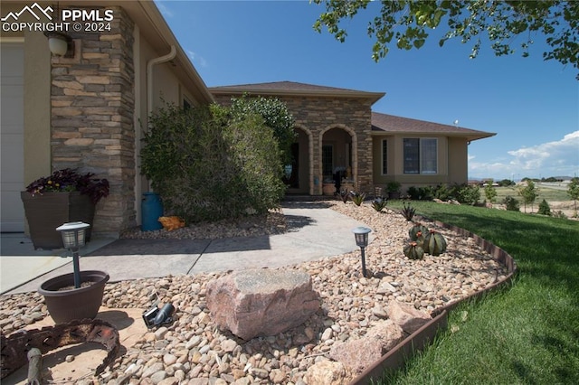 1933 Top Notch Trl, Penrose, CO 81240 - view of front of home with stone siding and a front yard
