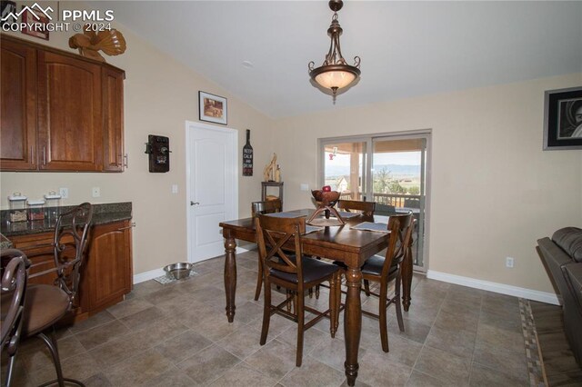 1933 Top Notch Trl, Penrose, CO 81240 - dining area with dark tile patterned floors, vaulted ceiling, and baseboards