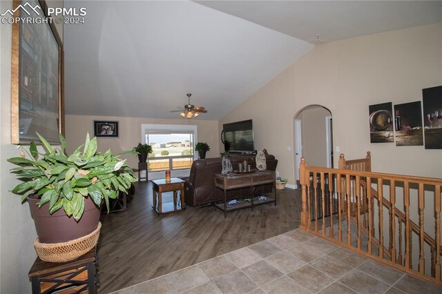 1933 Top Notch Trl, Penrose, CO 81240 - living room with wood finished floors, vaulted ceiling, arched walkways, a ceiling fan, and baseboards