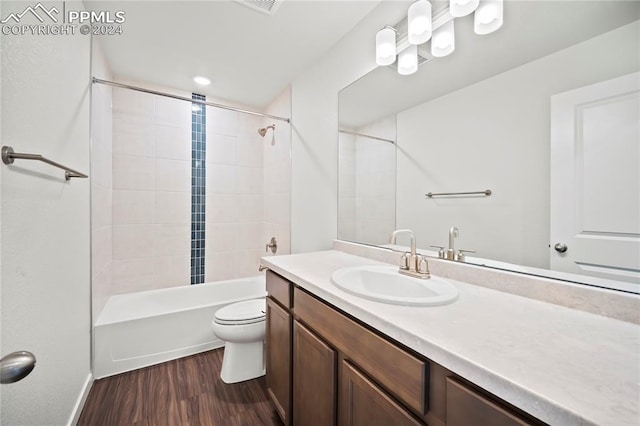 full bathroom with toilet, bathing tub / shower combination, wood finished floors, and vanity