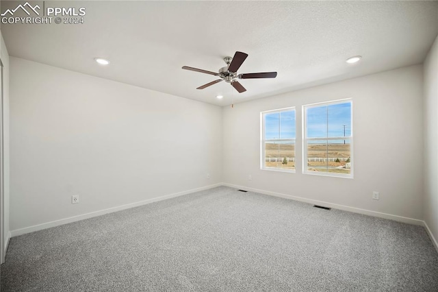 spare room featuring baseboards, ceiling fan, a textured ceiling, carpet floors, and recessed lighting