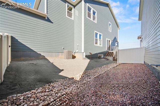 exterior space with a patio, central AC unit, and fence