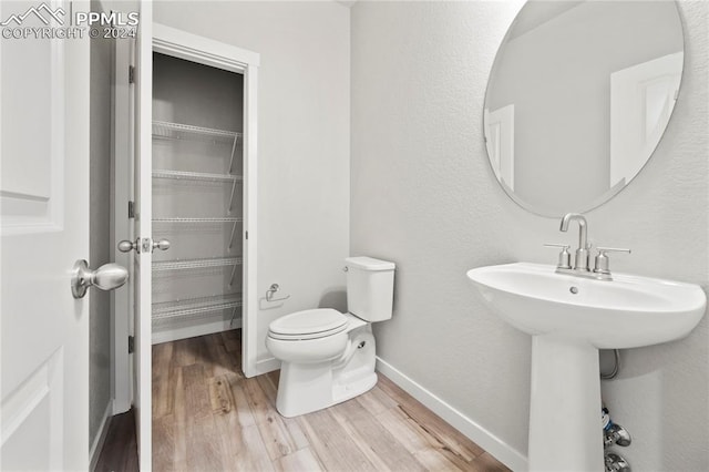 bathroom featuring hardwood / wood-style floors, toilet, and sink