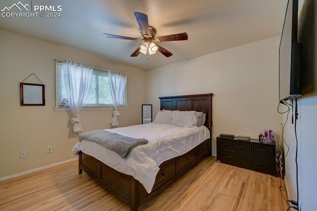 bedroom with light wood-type flooring and ceiling fan