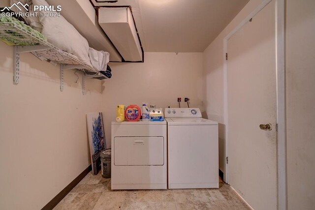 washroom with washer and dryer and light tile patterned floors