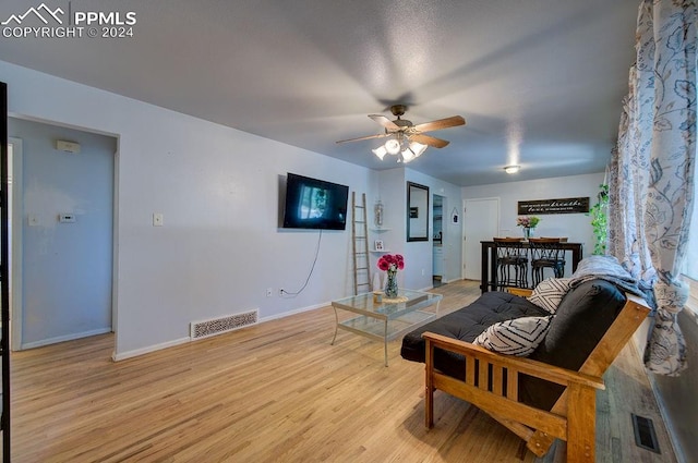 living area with light hardwood / wood-style flooring and ceiling fan