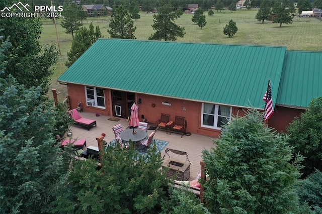 back of house with a wooden deck