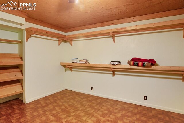 spacious closet with parquet floors