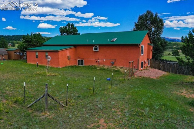 rear view of property with a yard