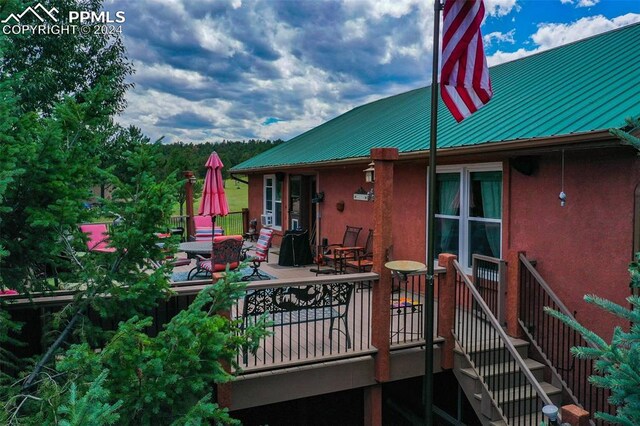 rear view of house featuring a deck