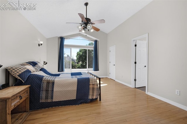 bedroom with ceiling fan, vaulted ceiling, and light hardwood / wood-style floors