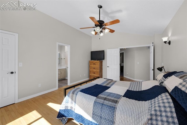 bedroom with ceiling fan, vaulted ceiling, connected bathroom, and light hardwood / wood-style floors