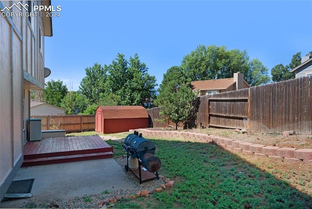 view of yard with a shed and a wooden deck