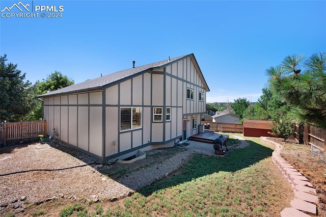 back of property featuring a lawn