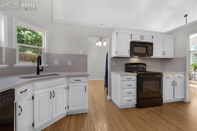 kitchen with sink, light wood-type flooring, black appliances, and backsplash