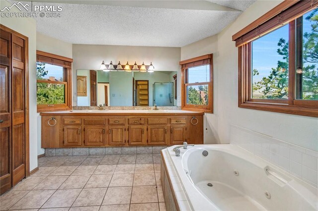 bathroom with double sink vanity, a textured ceiling, and tile patterned flooring