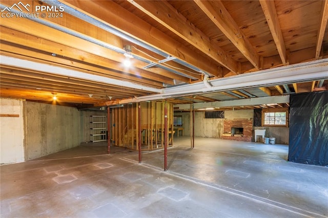 basement with a brick fireplace