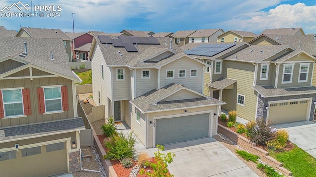 view of front of home featuring a garage and solar panels