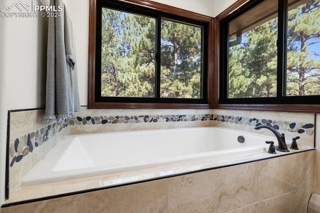 bathroom featuring a relaxing tiled tub