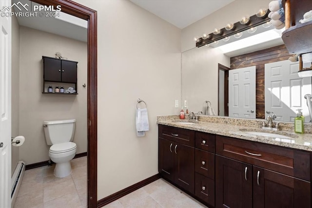 bathroom with a baseboard radiator, vanity, tile patterned floors, and toilet