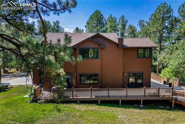 back of house featuring a yard and a deck