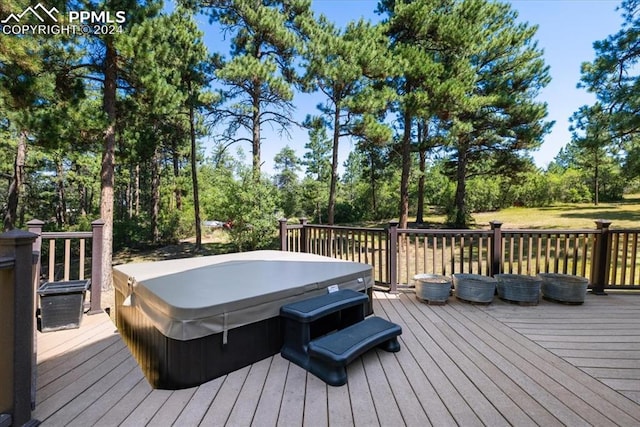 wooden terrace with a covered hot tub