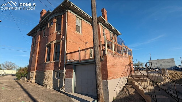 view of side of home featuring a garage