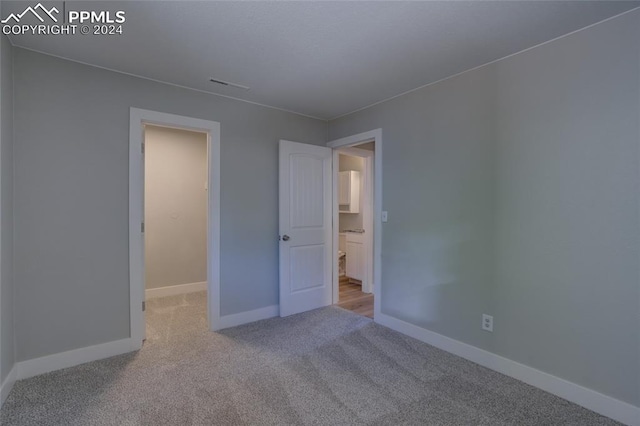 unfurnished bedroom with light colored carpet