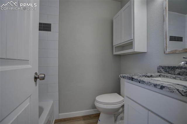 bathroom featuring vanity, hardwood / wood-style floors, and toilet