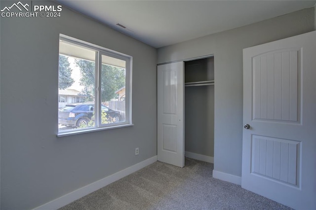 unfurnished bedroom featuring a closet and carpet flooring