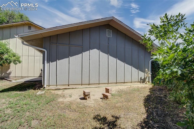 view of property exterior with a storage shed