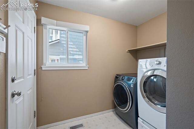 laundry area with separate washer and dryer