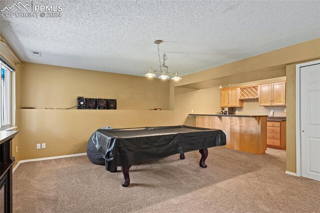 recreation room with pool table, light colored carpet, and a textured ceiling