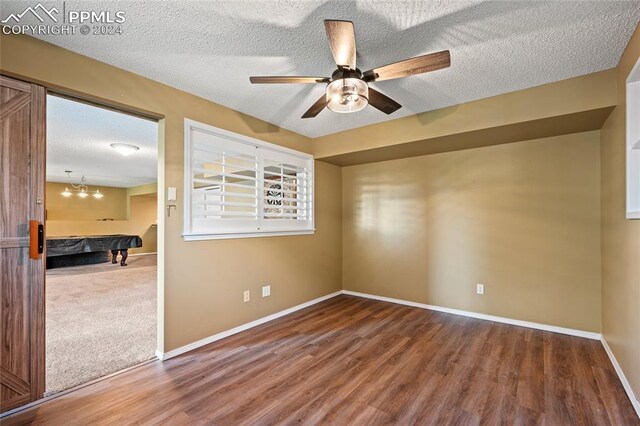 carpeted spare room featuring a textured ceiling, ceiling fan, and pool table