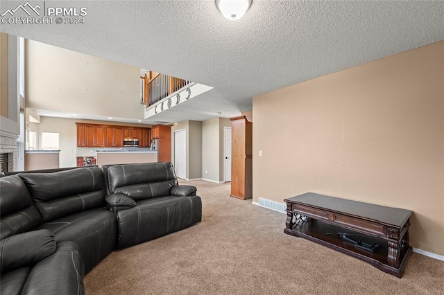 living room with a fireplace, a textured ceiling, and light colored carpet