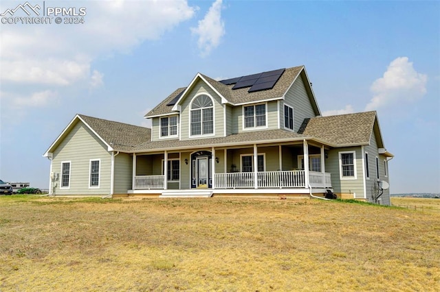 farmhouse-style home with a front lawn and covered porch