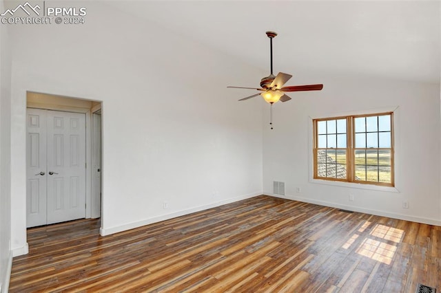 empty room with wood-type flooring, high vaulted ceiling, and ceiling fan