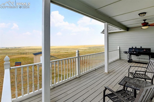 deck featuring a rural view and ceiling fan