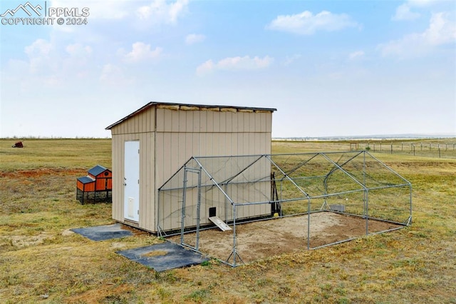 view of outdoor structure with a rural view