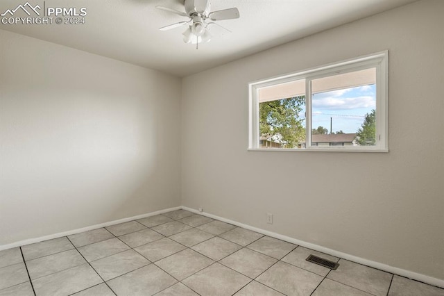 spare room with light tile patterned flooring and ceiling fan