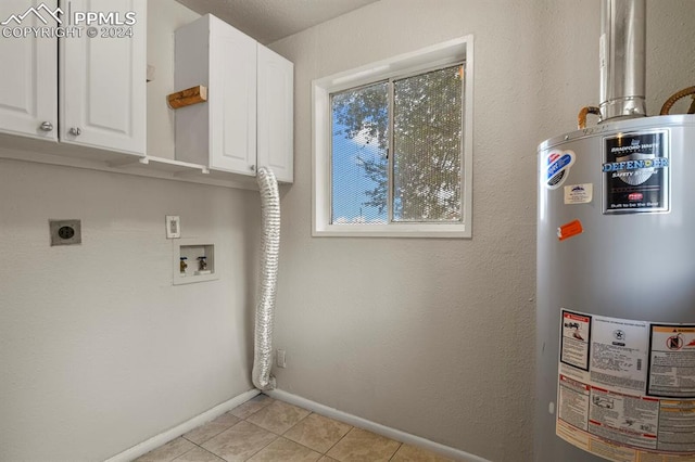 interior space with gas water heater, washer hookup, cabinets, hookup for an electric dryer, and light tile patterned floors