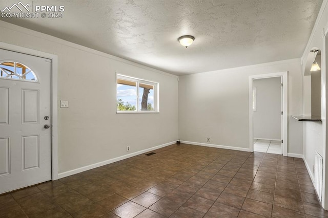 entrance foyer featuring dark tile patterned flooring